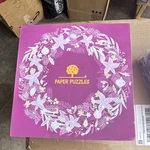 Paper Puzzles Floral Wreath Jigsaw Puzzle, Flowers Theme, Purple White Yellow. Fixed Price $14.68.