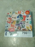New Puzzle World Postage Stamps 750 Piece Jigsaw 24" X 18" By Ceaco Usa Made. Fixed Price $12.00.
