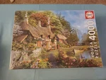 Educa 4000 Piece Jigsaw Puzzle Riverside Cottage In Bloom Brand New Box Wear. Fixed Price $69.99.