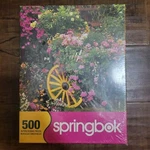 New! Springbok Puzzle 500 Piece Blooming Cart Flowers Garden Pink Green - Sealed. Fixed Price $15.00.