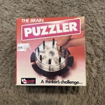 Vintage 1989 The Brain Puzzle Teaser Game Mag-nif Out-think Computer W/ Box. Fixed Price $145.00.
