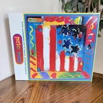 1999 Peter Max 550 Piece Flag With Heart Jigsaw Puzzle Sealed Ceaco No. 2324-1. Fixed Price $31.99.