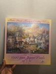 Main Street Along Country Village 1500 Piece Jigsaw Puzzle Sunsout. Fixed Price $39.99.