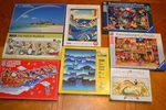 Lot Of 8 Jigsaw Puzzles, Mixed Brands, Used & Complete (no Missing Pieces). Fixed Price $40.00.